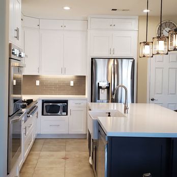 Desert Pride Construction & Painting - a large kitchen with white cabinets and stainless steel appliances - General Contractors Near Me - Indio, California Desert Pride Construction & Painting - a large kitchen with white cabinets and stainless steel appliances - General Contractors Near Me - Indio, California