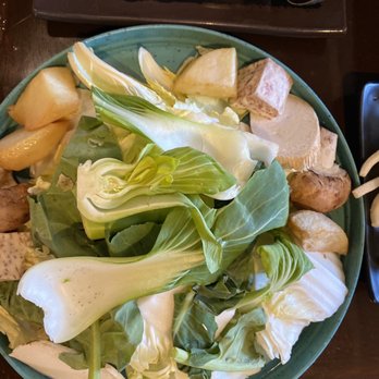 Zu Hot Pot - Assorted vegetables platter, waiting to be added to hot pot. - A bowl filled with fresh vegetables such as lettuce, potatoes, and taro, prepared for hot pot dining at Zu Hot Pot in Albuquerque. - Hot Pot Near Me - Albuquerque, New Mexico