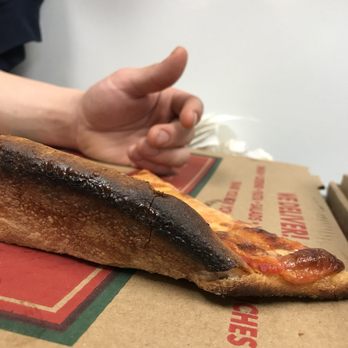 Pizzeria Bello - a person reaching for a piece of pizza - Italian Near Me - Brookfield, Connecticut