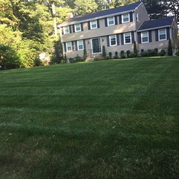 Four Paws Lawn Care - a house in the background - Lawn Services Near Me - Mashpee, Massachusetts Four Paws Lawn Care - a house in the background - Lawn Services Near Me - Mashpee, Massachusetts