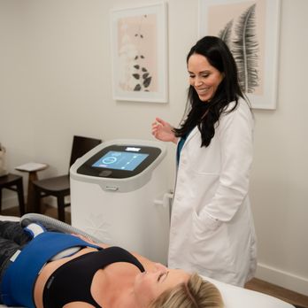 SkinSpirit - Expert practitioner Jenn Izzarelli helps her client build muscle and sculpt her abdomens with CoolTone. - Skin Care Near Me - Newport Beach, California SkinSpirit - Expert practitioner Jenn Izzarelli helps her client build muscle and sculpt her abdomens with CoolTone. - Skin Care Near Me - Newport Beach, California