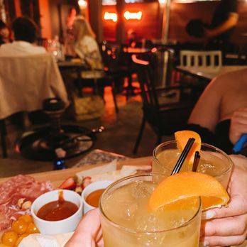The Lounge - a person holding a glass of orange juice - Lounges Near Me - Glendale, California The Lounge - a person holding a glass of orange juice - Lounges Near Me - Glendale, California