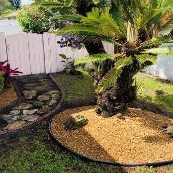 Quik Care Services - Installed lining around tree, removed old cedar chips and added new river rock. - Landscaping Near Me - Longwood, Florida Quik Care Services - Installed lining around tree, removed old cedar chips and added new river rock. - Landscaping Near Me - Longwood, Florida