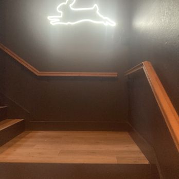 The White Rabbit Coffee House - Neon leaping white rabbit sign and steep stairs. - Coffee & Tea Near Me - Sherman, Texas The White Rabbit Coffee House - Neon leaping white rabbit sign and steep stairs. - Coffee & Tea Near Me - Sherman, Texas