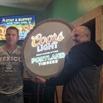O'Nammy's - two men holding a sign - Sports Bars Near Me - Saint Helens, Oregon