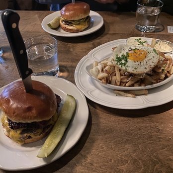 Au Cheval - Two singles with bacon and fries with an egg on top - Bars Near Me - Chicago, Illinois Au Cheval - Two singles with bacon and fries with an egg on top - Bars Near Me - Chicago, Illinois