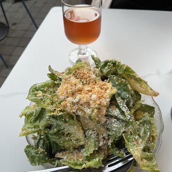 Rose Pizzeria - Spicy caesar salad with a glass of orange wine - Pizza Near Me - Berkeley, California Rose Pizzeria - Spicy caesar salad with a glass of orange wine - Pizza Near Me - Berkeley, California