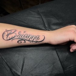 Savage Kat Tattoo - Custom name script tattoo on forearm