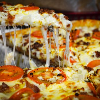Marco's Pizza - a slice being taken out of a pizza - Pizza Near Me - Paragould, Arkansas Marco's Pizza - a slice being taken out of a pizza - Pizza Near Me - Paragould, Arkansas