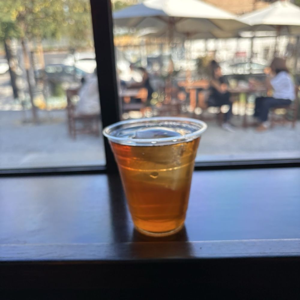 Loquat - Iced tea with outdoor seating area in the background - Coffee & Tea Near Me - Los Angeles, California Loquat - Iced tea with outdoor seating area in the background - Coffee & Tea Near Me - Los Angeles, California