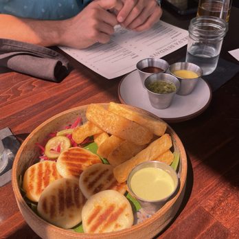 Selva - Arepas and yucca fries, comes with 3 sauces. My favorite is the green one. - Bars Near Me - Long Beach, California