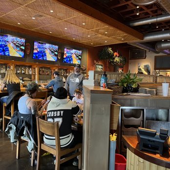 Islands Restaurant - a group of people sitting at a bar - Burgers Near Me - San Diego, California