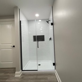 Striker Remodeling - a walk in shower with a glass door - General Contractors Near Me Striker Remodeling - a walk in shower with a glass door - General Contractors Near Me