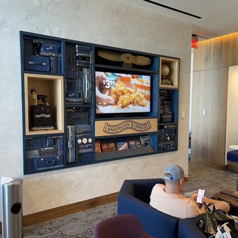 The Centurion Lounge - Bookcases decorated with travel manuals and vintage aircraft pieces and accessories - Airport Lounges Near Me - Las Vegas, Nevada
