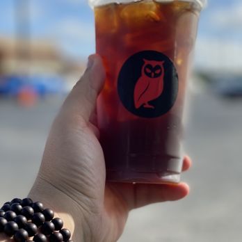 Red Owl Coffee - Macey Dr - a hand holding a cup of iced coffee - Coffee & Tea Near Me - Valdosta, Georgia Red Owl Coffee - Macey Dr - a hand holding a cup of iced coffee - Coffee & Tea Near Me - Valdosta, Georgia