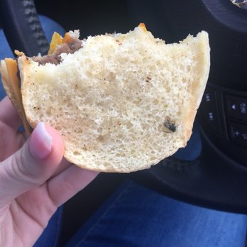 Wendy's - a hand holding a half eaten sandwich - Burgers Near Me - Red Lion, Pennsylvania