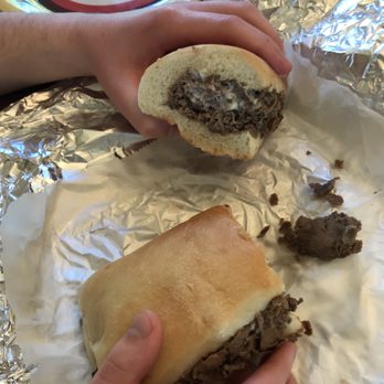 Tonys Pizza - a hand holding a half eaten sandwich - Pizza Near Me - Coopersburg, Pennsylvania Tonys Pizza - a hand holding a half eaten sandwich - Pizza Near Me - Coopersburg, Pennsylvania