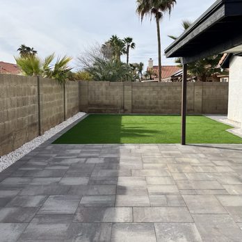 Nico's Landscaping - a patio with artificial grass - Landscaping Near Me