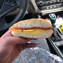 a hand holding a sandwich