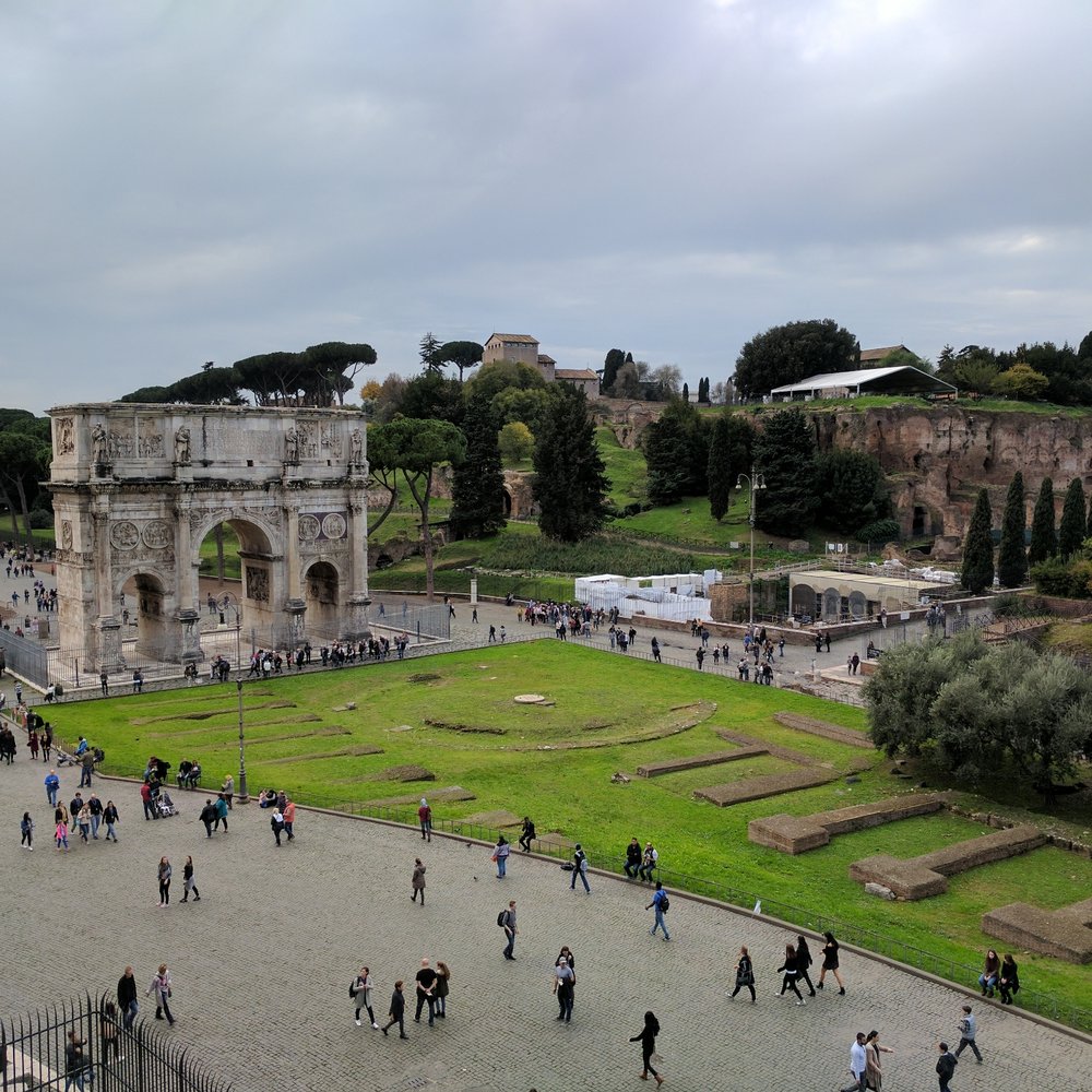 Colosseo - A view of the nearby arc - Local Flavor Near Me - Rome, RM