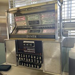 Cute retro jukebox at tables Cute retro jukebox at tables
