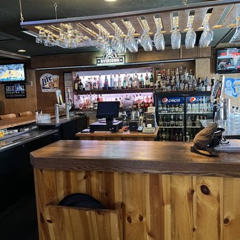 Meadows Restaurant - a bar with wooden counter and bar stools - American Near Me - Springfield, Ohio