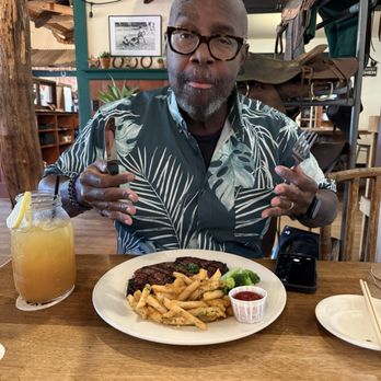 Wrangler's Steakhouse - Husband getting ready to dig into what was a perfectly cooked rib eye. - Steakhouses Near Me - Waimea, Hawaii