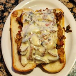 Sugar Bummm - Hot chicken sandwich. Chicken, onion, bellpepper, mushrooms with melted cheese on a toasted roll.