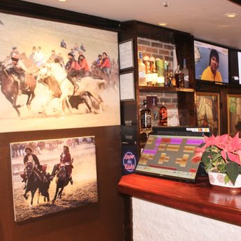 Aria Afghan Grill - a bar counter with a bunch of pictures on the wall - Kebab Near Me - Coquitlam, British Columbia