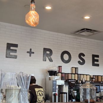E Rose Wellness - Back wall of the interior with branding, showing the work area with different ingredients behind the bar - Juice Bars & Smoothies Near Me - Nashville, Tennessee