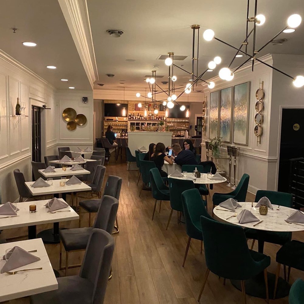 Sainte-George - a dining room with tables and chairs - New American Near Me - St. Augustine, Florida Sainte-George - a dining room with tables and chairs - New American Near Me - St. Augustine, Florida