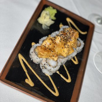 Ocean Prime - a plate of sushi with sauce and broccoli - Seafood Near Me - Dallas, Texas