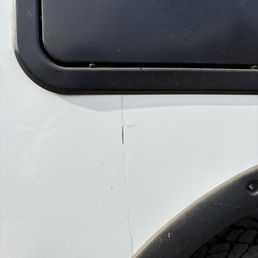 Body work failed and crack emerged shortly after repair Notice how they never bothered to caulk the wheel well.