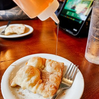 Ted's Café Escondido - a plate of crepes being drizzled with syrup - Tex-Mex Near Me - Norman, Oklahoma Ted's Café Escondido - a plate of crepes being drizzled with syrup - Tex-Mex Near Me - Norman, Oklahoma