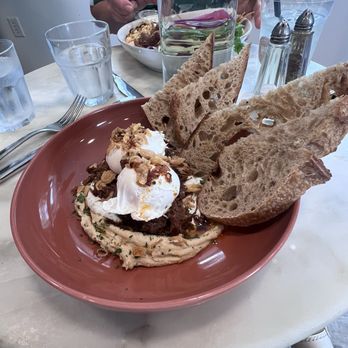 Hudson Botanical - Turkish-ish dish, my ALL TIME FAVORITE!  Two poached eggs, braised lamb over humus served with sourdough bread! - Breakfast & Brunch Near Me - Smoketown, Pennsylvania