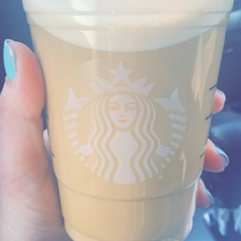 Starbucks - a hand holding a cup of coffee - Coffee & Tea Near Me - Derby, Kansas Starbucks - a hand holding a cup of coffee - Coffee & Tea Near Me - Derby, Kansas