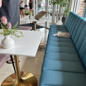 Fulla Beans - a table with a vase of flowers on it - Coffee & Tea Near Me - Itasca, Illinois