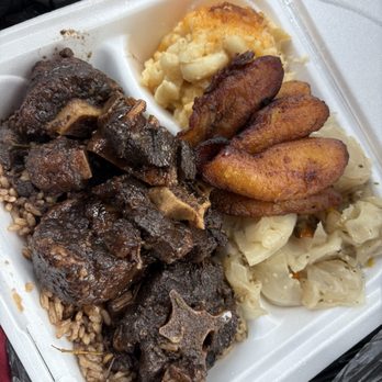 Jamaican On The Go - Oxtail tail with rice and beans, cabbage, sweet plantain and baked macaroni - Caribbean Near Me Jamaican On The Go - Oxtail tail with rice and beans, cabbage, sweet plantain and baked macaroni - Caribbean Near Me