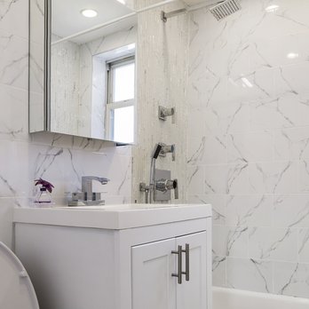 Emile's Amenities - For this job, we replaced all the wall tiles, the shower body, the sink/vanity/ mirror and added high hat lights. - General Contractors Near Me Emile's Amenities - For this job, we replaced all the wall tiles, the shower body, the sink/vanity/ mirror and added high hat lights. - General Contractors Near Me