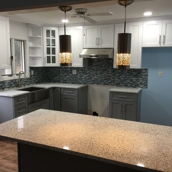 YC Renovation - a kitchen with granite countertops and white cabinets - General Contractors Near Me YC Renovation - a kitchen with granite countertops and white cabinets - General Contractors Near Me