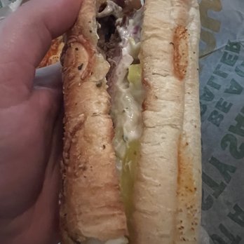 Subway - a person holding a sandwich in their hand - Sandwiches Near Me - Halletsville, Texas Subway - a person holding a sandwich in their hand - Sandwiches Near Me - Halletsville, Texas