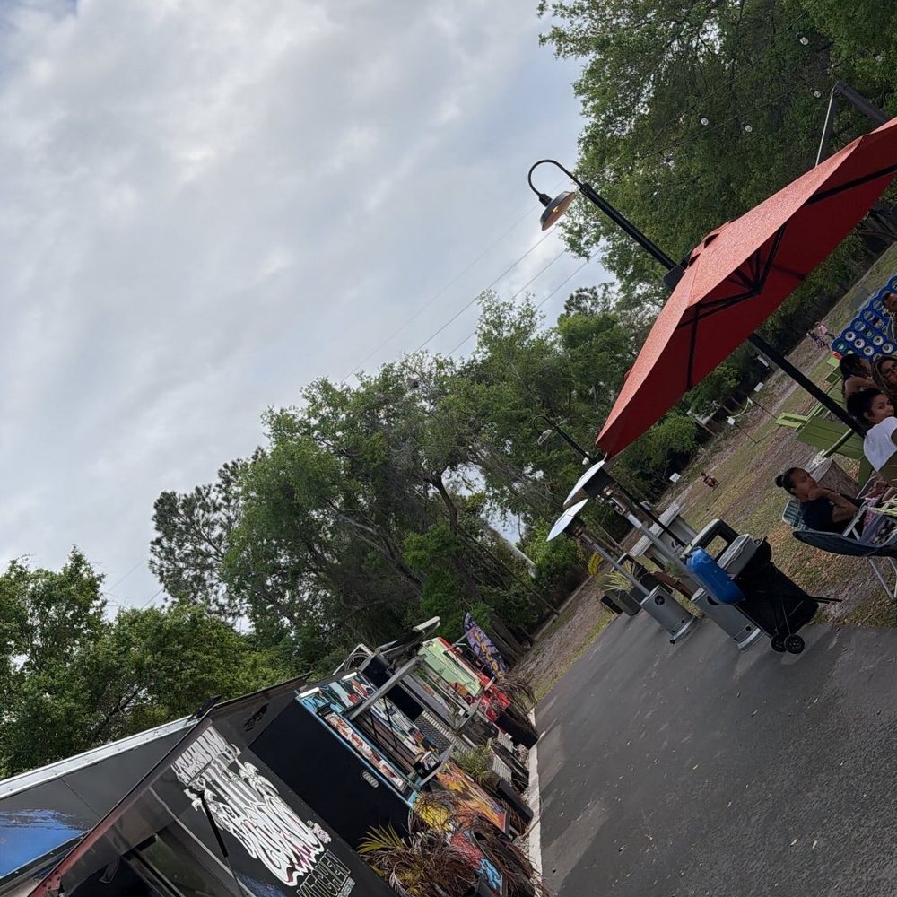 Food trucks lined up at the backyard