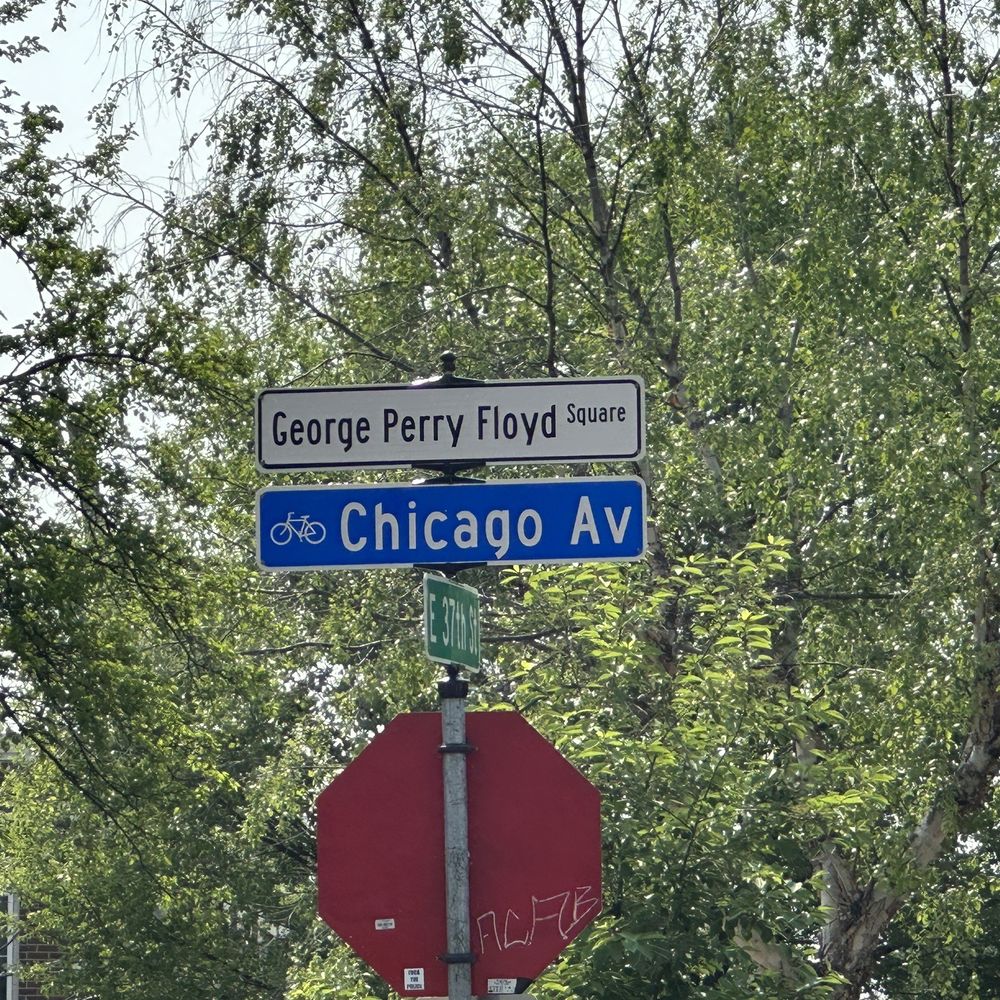 Smoke In The Pit - a stop sign and street signs - Barbeque Near Me - Minneapolis, Minnesota
