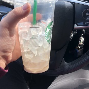 Fred Meyer - a hand holding a starbucks drink - Grocery Near Me - Cornelius, Oregon