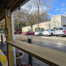 The cars parked along the side of the parking lot.