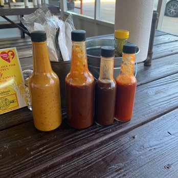 The Pig & Pint - BBQ sauces on the left. Hot sauces to the right in the smaller bottles. - Barbeque Near Me - Jackson, Mississippi The Pig & Pint - BBQ sauces on the left. Hot sauces to the right in the smaller bottles. - Barbeque Near Me - Jackson, Mississippi