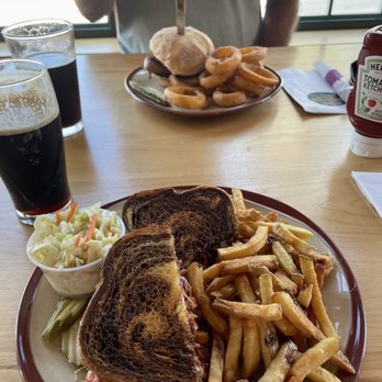 Sarges Pub & Grub - Pastrami Reuben sandwich & fries & Cole slaw...and in the background is a chicken sandwiches with onion rings. - Seafood Near Me - Rangeley, Maine Sarges Pub & Grub - Pastrami Reuben sandwich & fries & Cole slaw...and in the background is a chicken sandwiches with onion rings. - Seafood Near Me - Rangeley, Maine