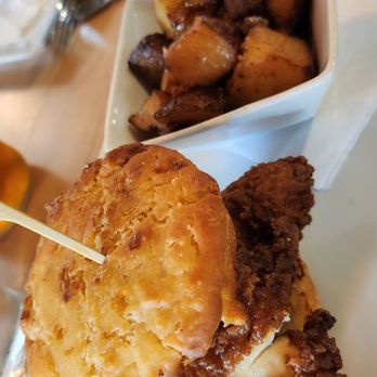 Scratch Kitchen and Taproom - Fried chicken sammie...sweet bbq sauce with a spicy biscuit!Taters with green pepper and onion were tasty. - American Near Me - Cary, North Carolina