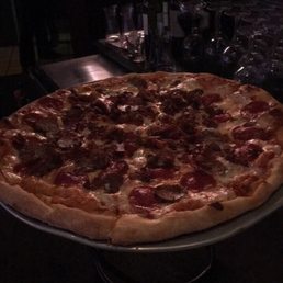 a pepperoni pizza on a metal platter a pepperoni pizza on a metal platter