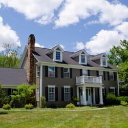 CertaPro Painters of Chagrin Falls, OH - White trimwork compliment the dark brown shutters against the dark tan siding.